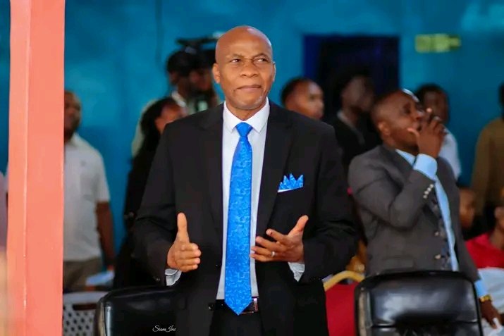 Bishop John Kaberere with open hands in worship