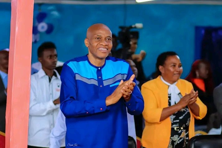 Bishop John Kaberere clapping with a smile
