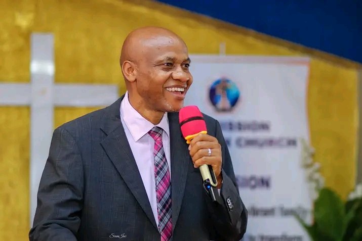 Bishop John Kaberere ministering with a microphone